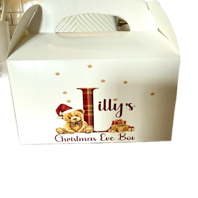 Cardboard party boxes in white with a personalised picture on the front perfect for a Christmas Eve box.