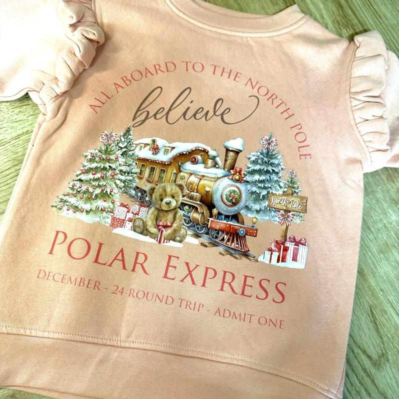 Young girls sweatshirt with frilly arms in a dusty pink with polar express themed