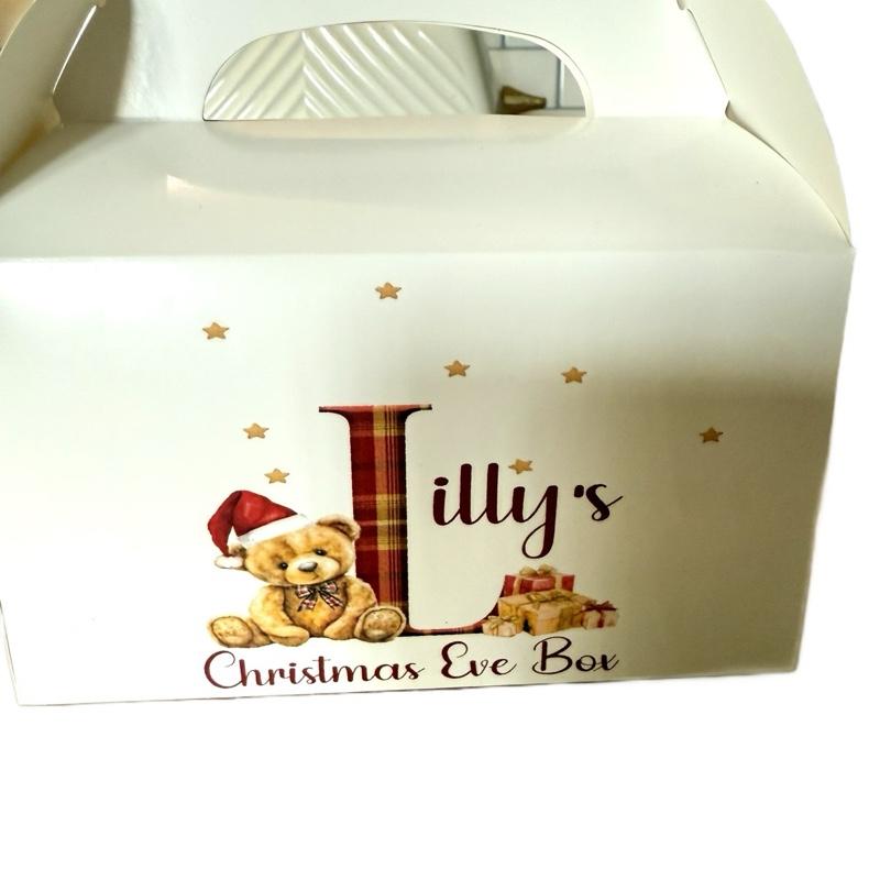 Cardboard party boxes in white with a personalised picture on the front perfect for a Christmas Eve box.
